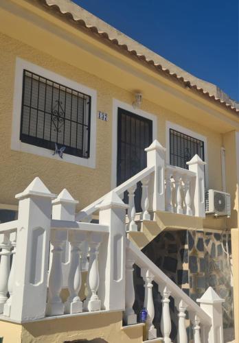 a house with a staircase and a balcony at Super Cute Camposol 2 bed with Community Pool in Mazarrón