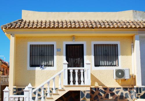a house with two windows and a balcony at Super Cute Camposol 2 bed with Community Pool in Mazarrón