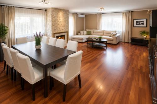 a living room with a dining room table and white chairs at Magnifica Planet Costa Dorada in Cambrils