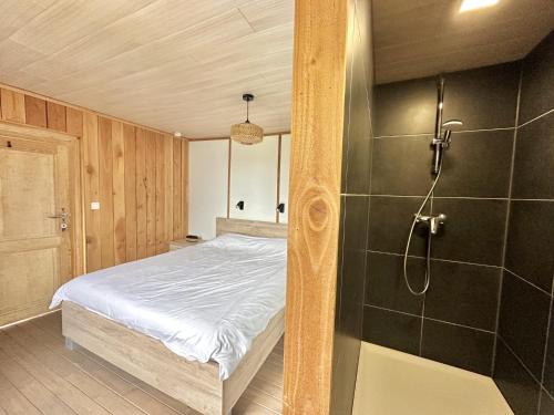 a bedroom with a bed and a shower at Relais de Zoé in Gesves
