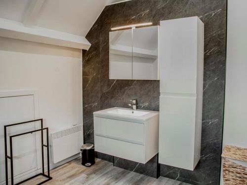 a bathroom with a sink and a mirror at Lac Bleu 39 in Lacapelle-Marival