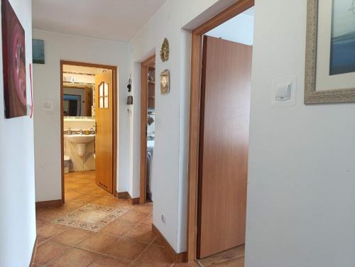 a hallway with two doors and a bathroom with a sink at Apartament w Bieszczadach in Wołkowyja