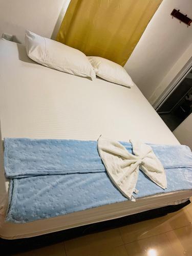 a bed with two pillows and a bow on it at Hostal La Bendición Buritaca in Santa Marta