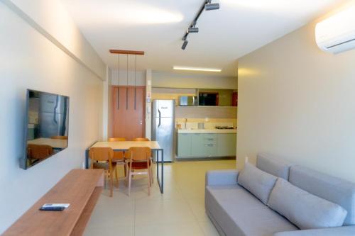 a living room and kitchen with a couch and a table at Top Unique Maceió in Maceió