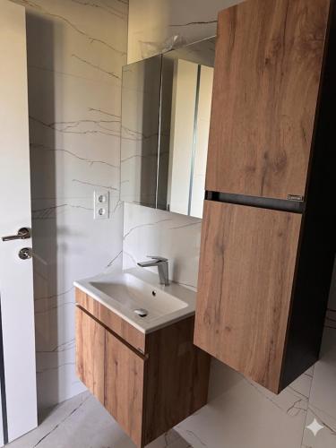a bathroom with a sink and a mirror at Villa ZANS in Gradačac