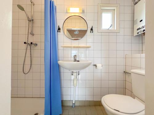 a bathroom with a sink and a toilet and a mirror at Seagul in Ellemeet