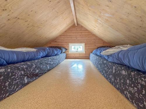 a room with two couches in a attic at Seagul in Ellemeet