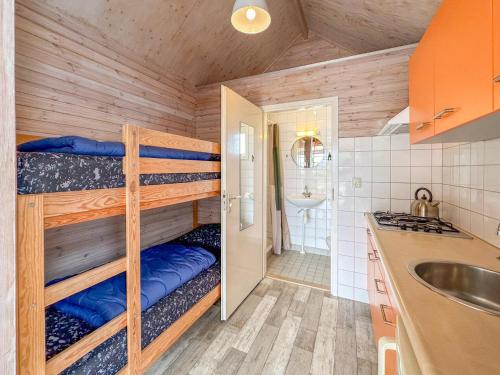 a small kitchen with bunk beds in a room at Beach Blue in Ellemeet