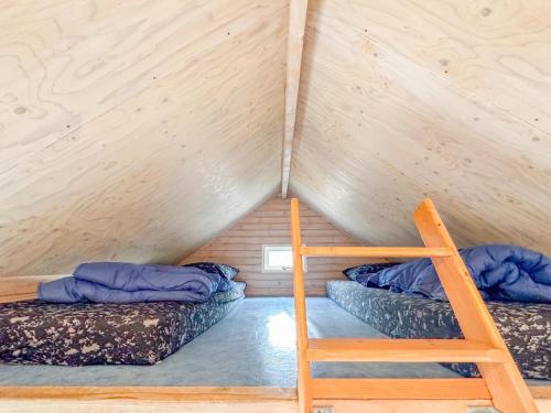 a room with two bunk beds and a ladder at Beach Blue in Ellemeet