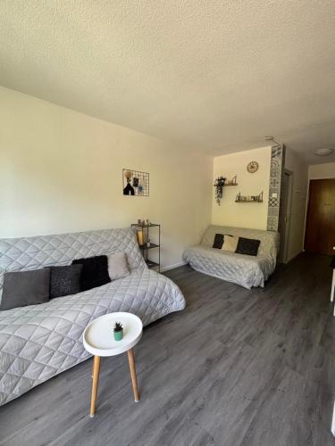a bedroom with a bed and a table in it at Studio le balcon pied des pistes in Villard-de-Lans