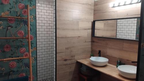 a bathroom with two sinks and a mirror at Le Clos de Saussac in Yssingeaux
