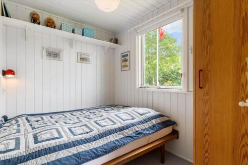 a bedroom with a bed and a window at LF15083-Farso-Illeris-153 in Hole