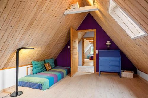 a room with a bed in the middle of a attic at FA030-Faxe-Bogebakken-6 in Faxe