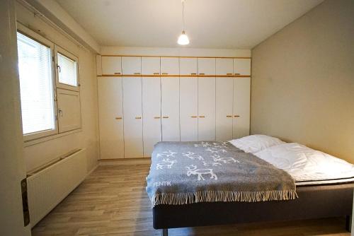 a small bedroom with a bed and a window at Aurora Nest in Rovaniemi