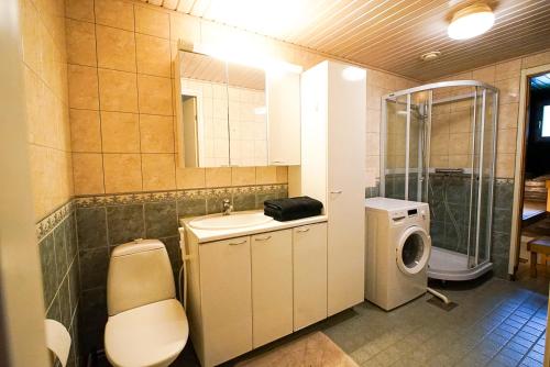 a bathroom with a sink and a washing machine at Aurora Nest in Rovaniemi