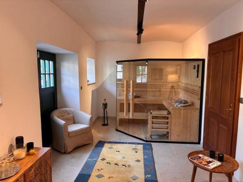 a living room with a large kitchen with a chair at Leichtfried 1884 - Boutique Appartments in Möbersdorf