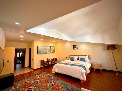 a bedroom with a large bed and a living room at 2149 Hotel in Khorog