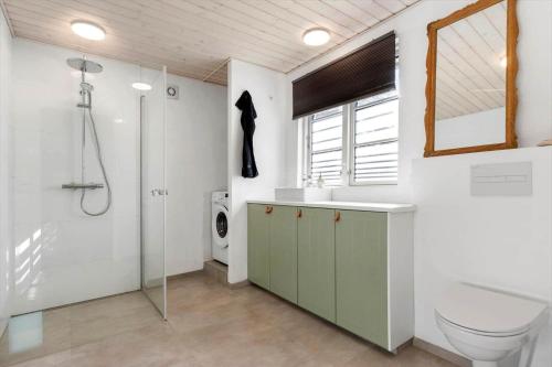 a bathroom with a shower and a toilet and a sink at 8880-Grenaa-Lyngtoften-49 in Selkær