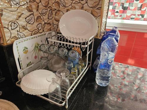 a group of bottles and containers sitting on a table at Café de Mazagran in Mostaganem