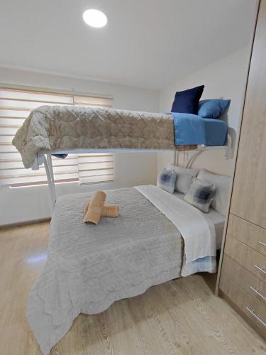 a bedroom with a bunk bed with a stuffed animal on it at Casa Central in Cuenca