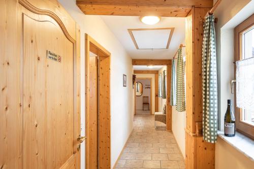 a hallway with wood paneling and a door at Winzerhof Nagel in Dettelbach