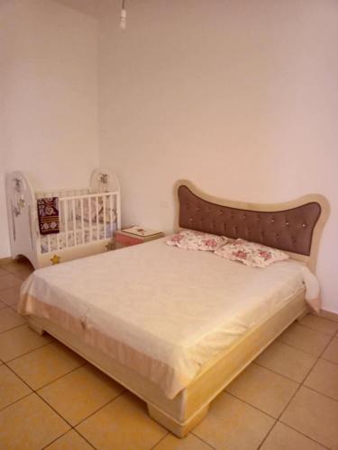 a bedroom with a large bed with a headboard at Dar Si Lamin 2 in Kelibia