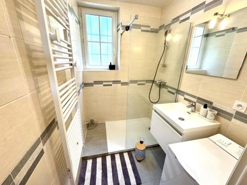 a small bathroom with a sink and a shower at La Rivière Enchantée in Peyraud