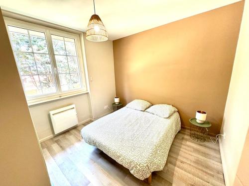 a small bedroom with a bed and a window at La Rivière Enchantée in Peyraud