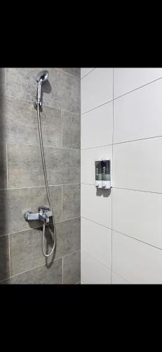 a bathroom with a shower with a shower head at Podium aparment in Kuching