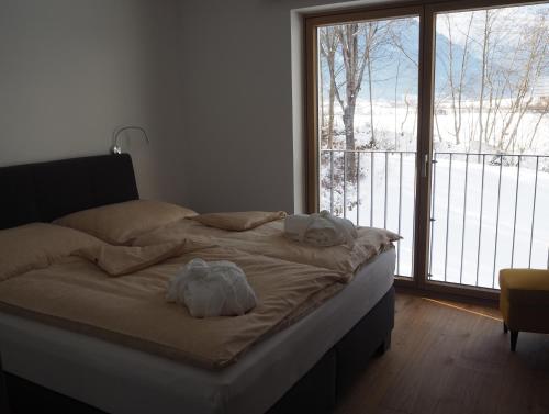 a bed with towels on it in a room with a window at Apartment Smaragdblick Wildkogel in Bramberg am Wildkogel