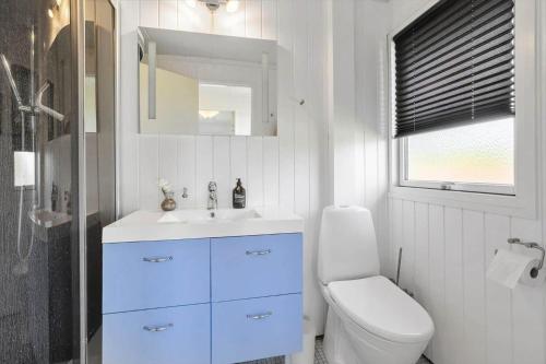 a white bathroom with a sink and a toilet at SL364-Slagelse-Hirsevangen-4 in Strandlyst