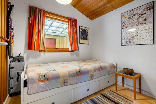 a small bedroom with a bed and a window at SL365-Rude-Vejrovej-1 in Bisserup Strand