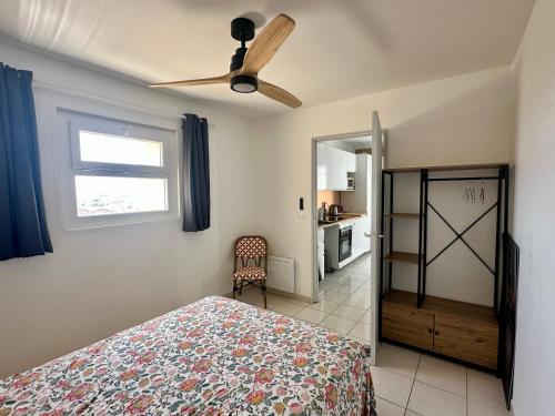 a bedroom with a bed and a ceiling fan at The Rave in Sète