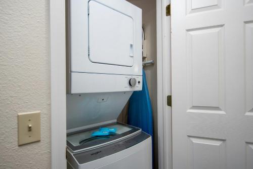 a refrigerator with its door open next to a door at Club Wyndham Tamarack in Wisconsin Dells