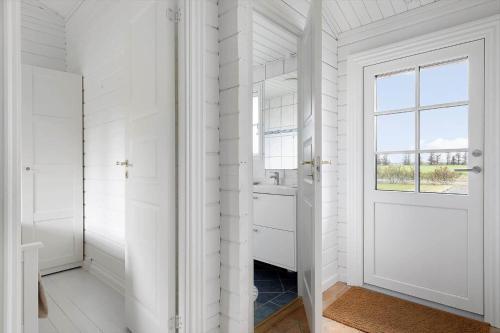 a white hallway with a door and a window at TV1729-Jerup-Engdraget-16 in Bratten Strand