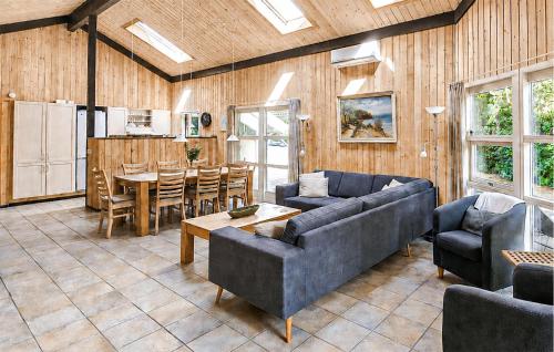 a living room with two couches and a table at Pet Friendly Home In Oksbøl With Sauna in Oksbøl