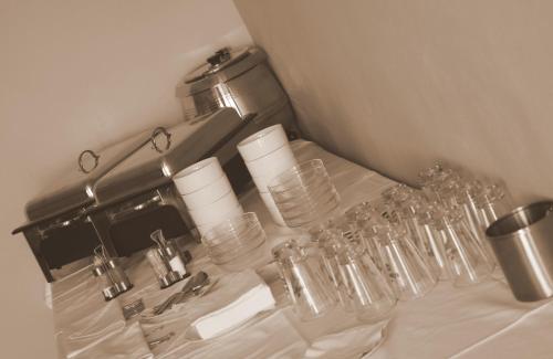 a bunch of glasses sitting on top of a table at Penzion a CaféRestaurant U lávky in Chrudim