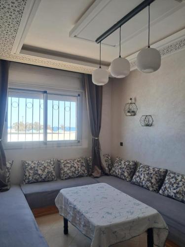 a living room with a couch and a table at mdiq in M'diq