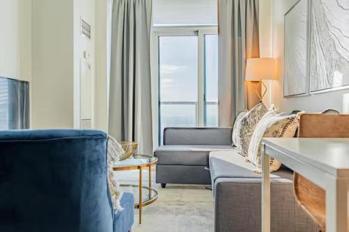 a living room with a couch and a chair at Mississauga Downtown Condos in Mississauga