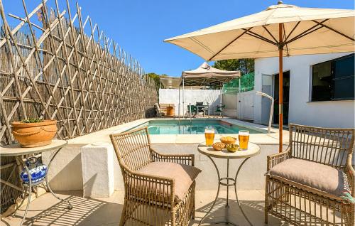 a patio with two chairs and a table with an umbrella at Lovely Home In Abarán in Abarán