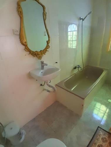 a bathroom with a sink and a toilet and a mirror at San Marcelo De Tangier in Tangier