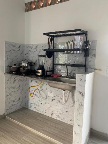 a kitchen with a counter with pots and pans at Ambar Apartahotel - Clasico in San Luis