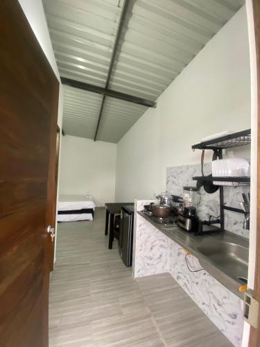 a kitchen with a counter with pots and pans at Ambar Apartahotel - Clasico in San Luis