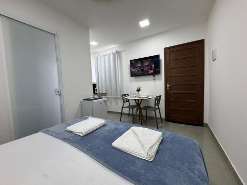 a bedroom with a bed with two towels on it at Pousada 8 Mares in Arraial do Cabo