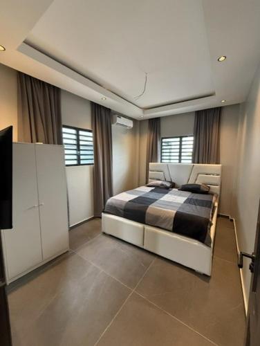 a bedroom with a bed and a flat screen tv at Boa Vista villa in Paramaribo