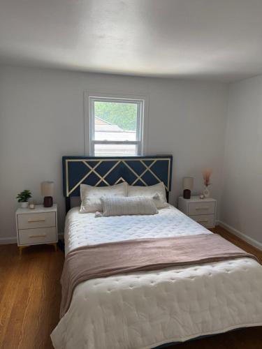 a bedroom with a large bed with two night stands at Boho room in house in New Haven