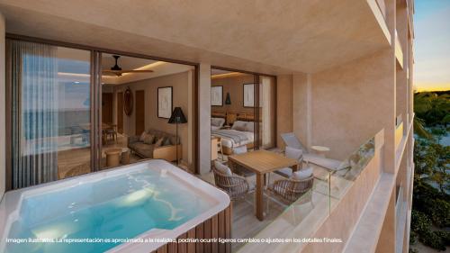 a jacuzzi tub on a balcony with a living room at Inna Resort & Spa in Puerto Morelos