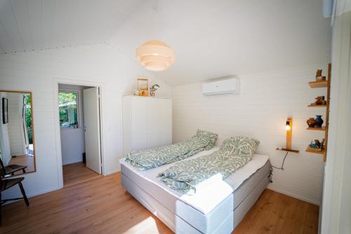 a living room with a couch in a room at Holiday house close to nature in Glesborg