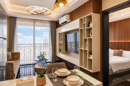 a hotel room with a bed and a dining table at Pinnacle Moments Residence in Phnom Penh
