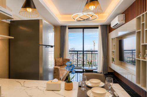a kitchen and living room with a large window at Pinnacle Moments Residence in Phnom Penh